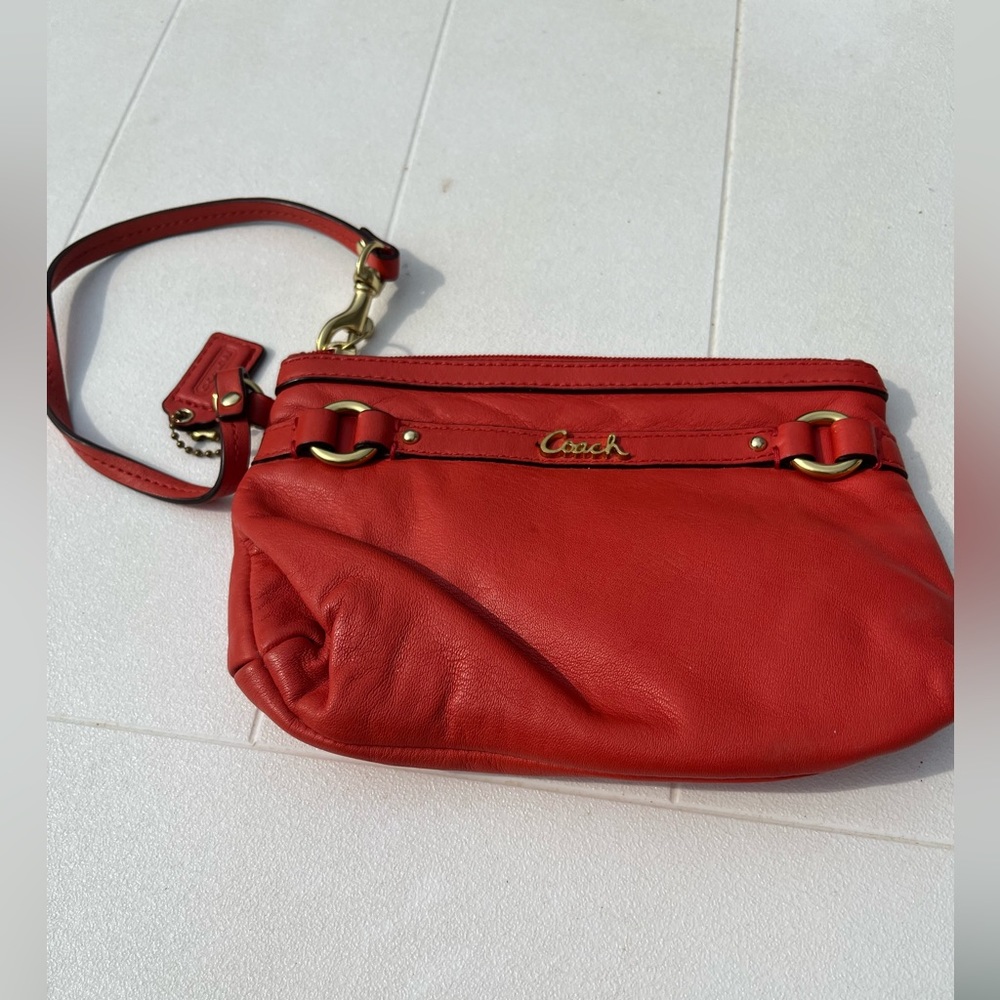 Women Coach outlet wristlet orange and gold pre-loved, great condition!